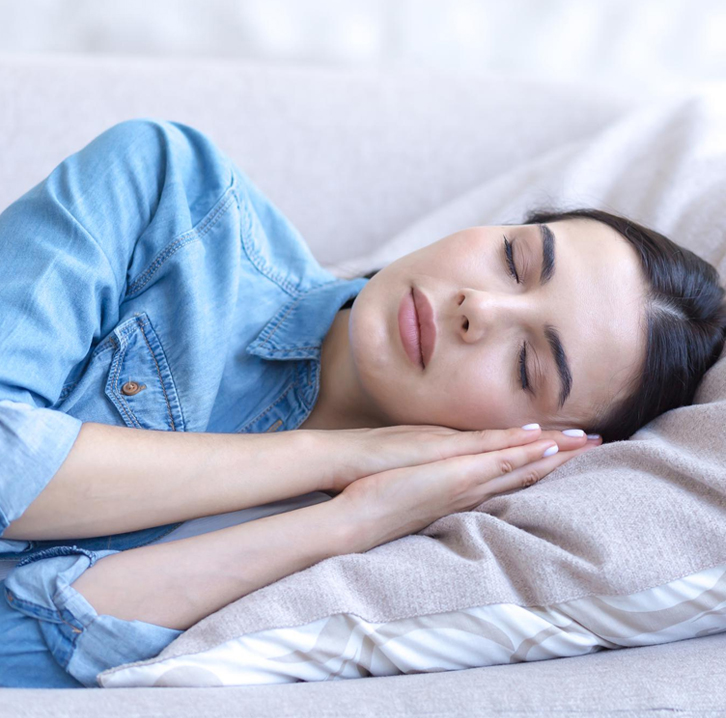 Woman sleeping peacefully in a comfortable bright room